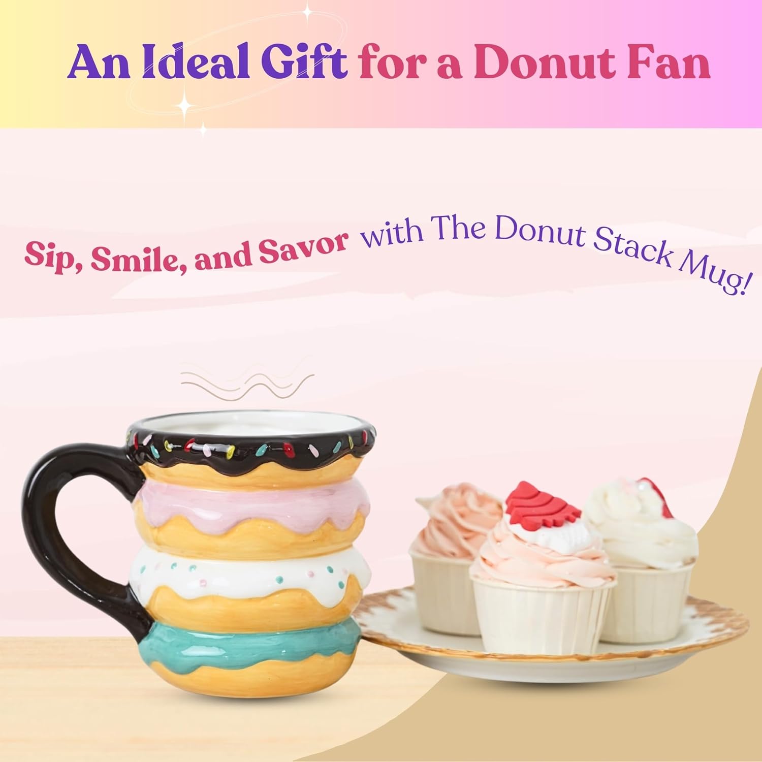 A colorful ceramic donut-shaped mug with a sprinkle design next to a plate of cupcakes, highlighting it as a perfect gift for donut lovers.