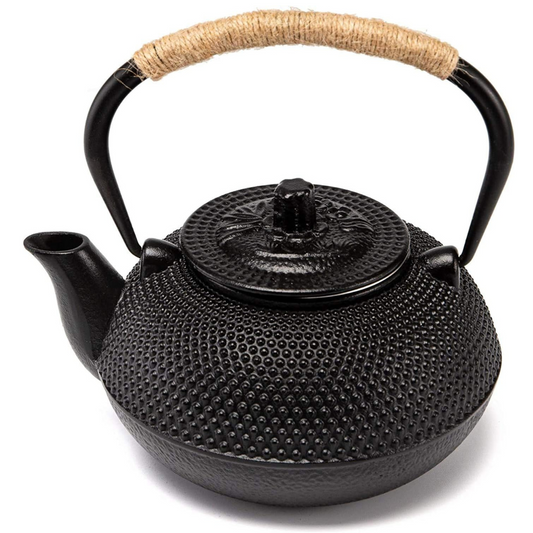  A traditional Japanese tetsubin cast iron teapot with a textured black surface and a woven rattan-wrapped handle.