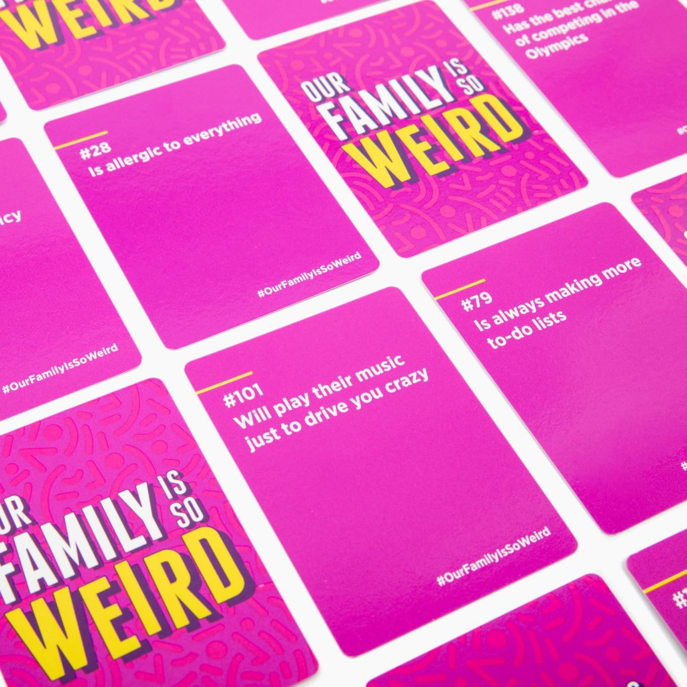 A close-up of pink cards from the "Our Family is So Weird" party game, featuring humorous traits and personality descriptions.