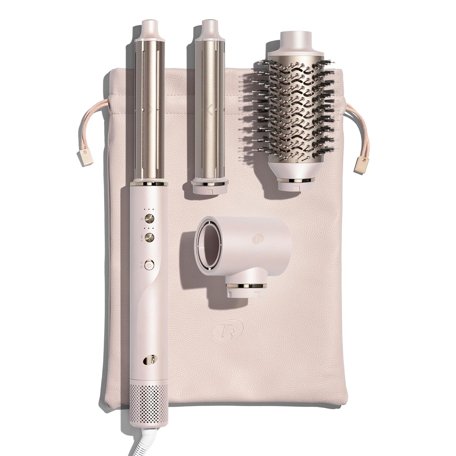 A sleek, modern hair styling set in a soft pink shade, including a main styling wand with control buttons, two curling barrels, a round brush attachment, and a concentrator nozzle. The set is neatly arranged on a matching storage pouch with drawstrings. The design is elegant, with metallic accents and a contemporary aesthetic, suggesting a high-end multi-styler and blowout system for various hairstyling needs.