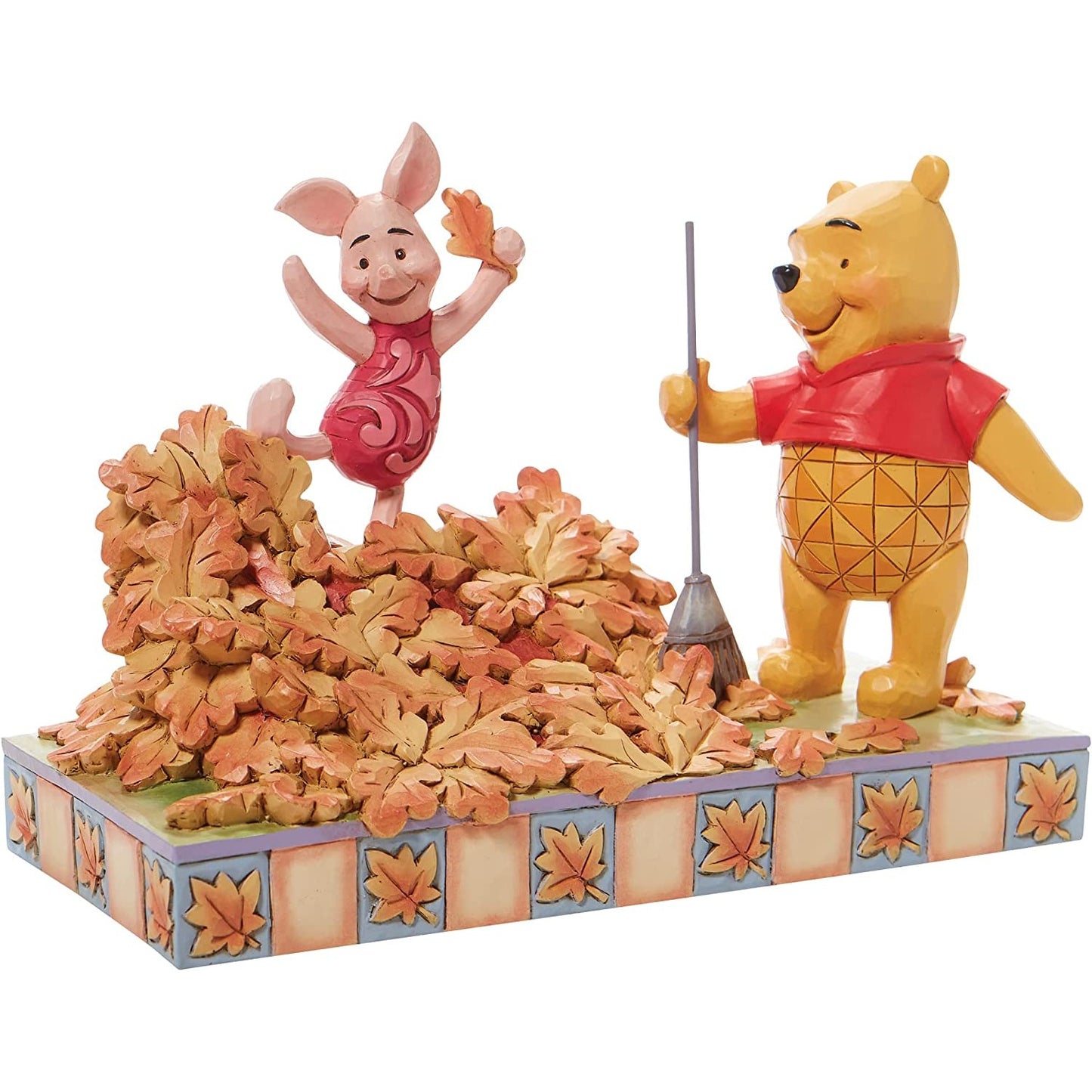 A figurine of Winnie The Pooh and Piglet.